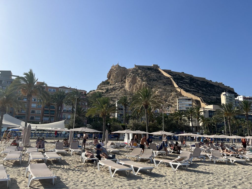 Postiguet beach sun beds with Mount Benacantil and the Castle of Alicante in the background