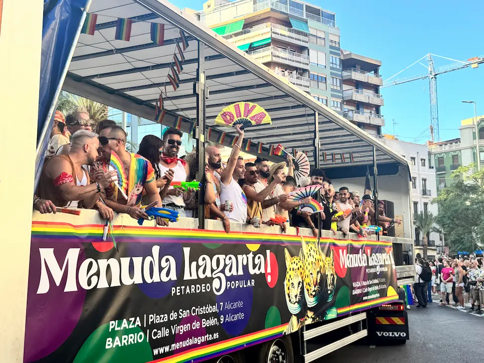 Alicante Pride march with crowds and rainbow flags in the city centre
